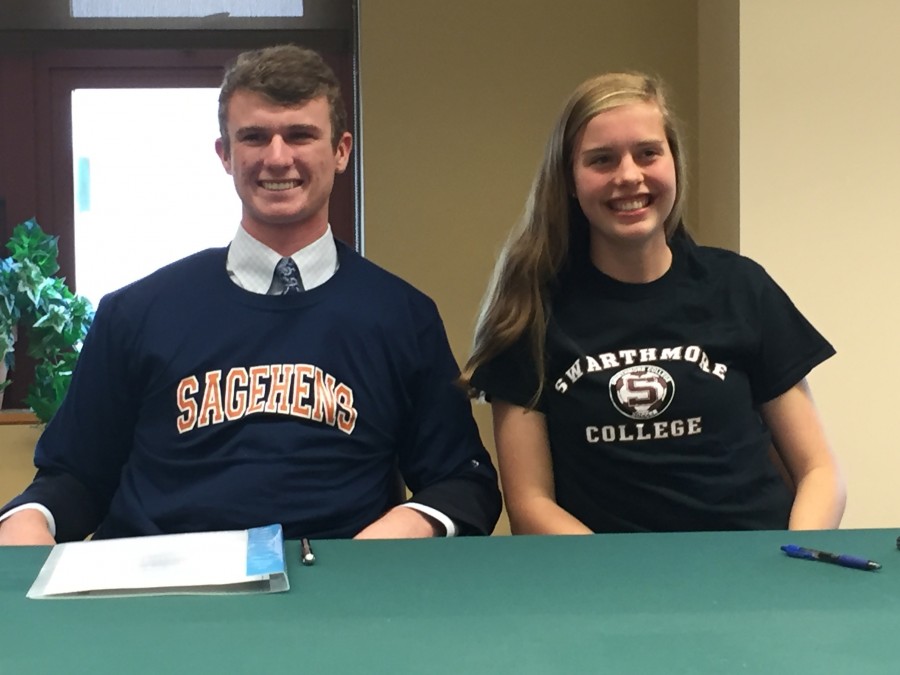 Connor and Maddy slip on their college tees after signing at school on Wednesday