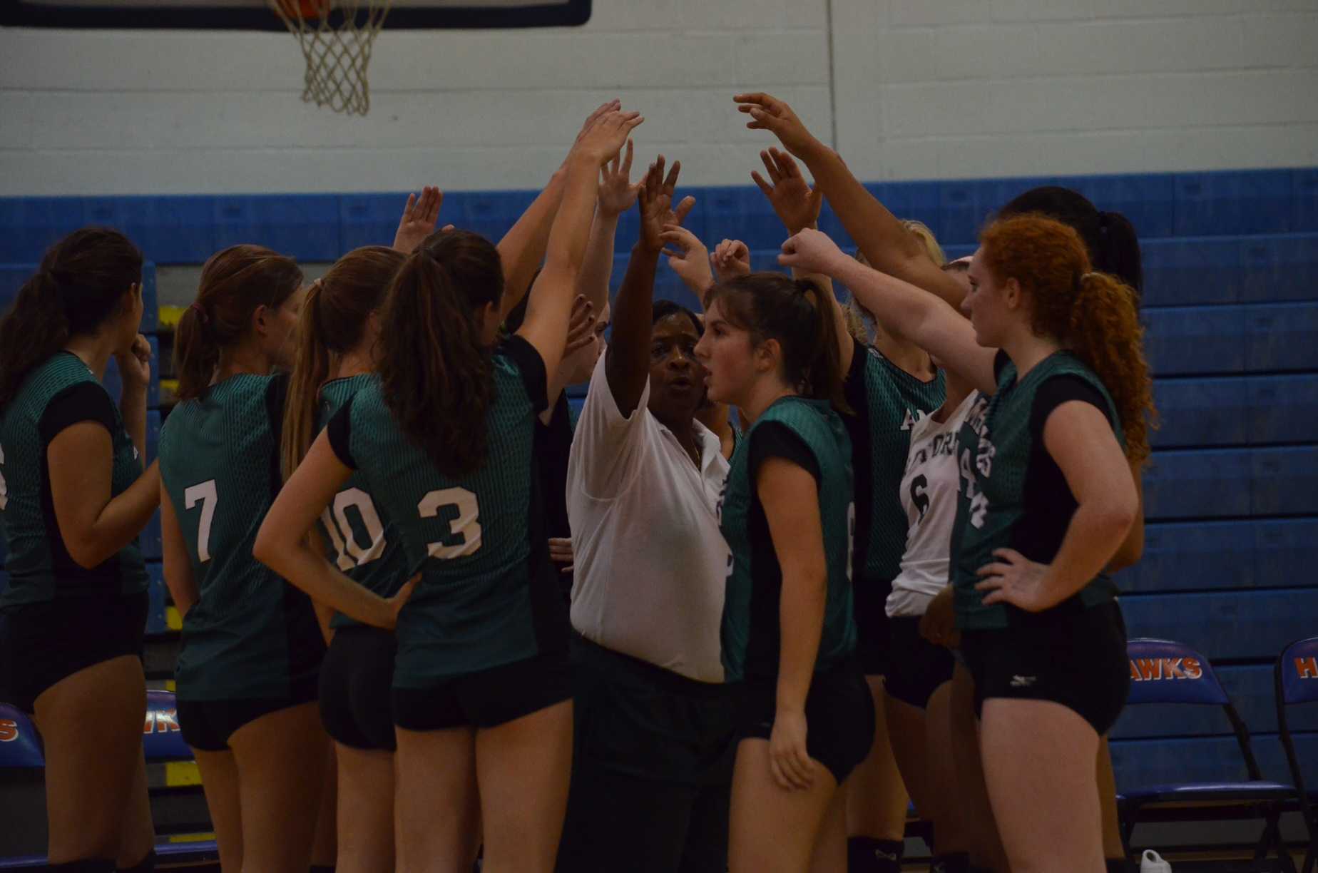 Raptor volleyball's fierce leader Coach Williams leads the team huddle before the win against the Hanahan Hawks.