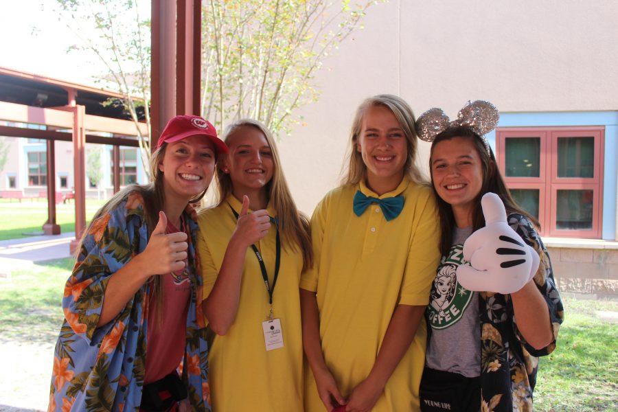 Disney World tourists Gabi Rauls and Blake Bernard pose for a picture with Tweedle Dee and Tweedle Dum
