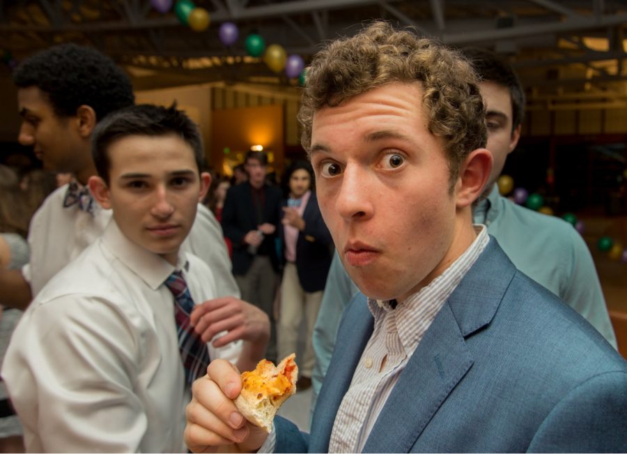 Seniors Aidan Gomez and Chase Michaelsend enjoy some pizza on the dance floor