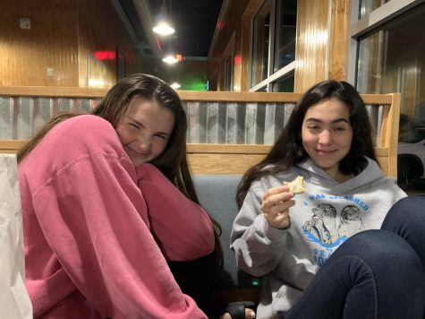 Presidents Angeline Krupa (left) and Gabby Ziegler (right) discussing Nihilism over dinner at Cookout.
